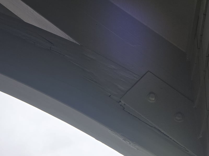 curved glulam beam cracked and rotting