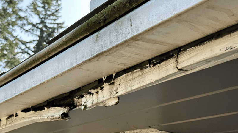 water leaking behind gutter