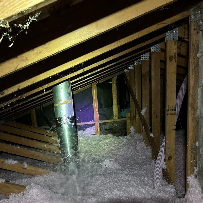Metal duct standing in fresh blown insulation during an attic insulation job