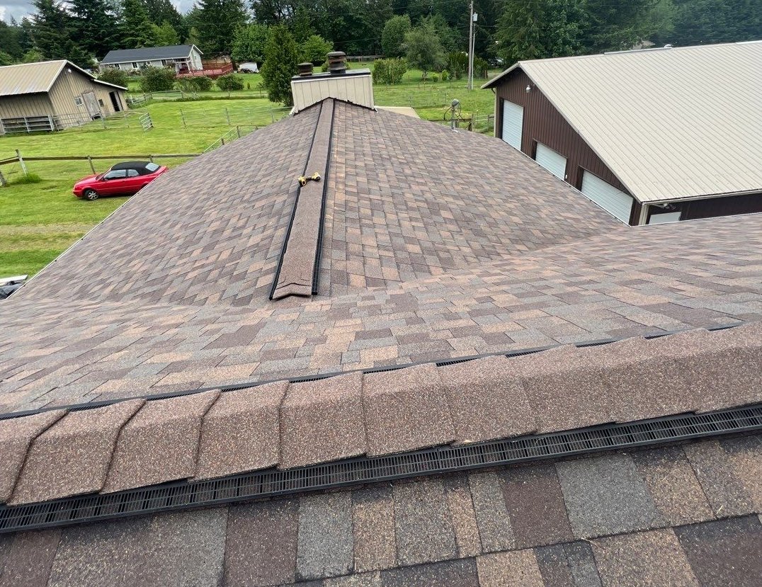 Ridge vent running along the peak of a new shingle roof