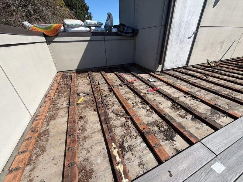 debris accumulated under boards rooftop deck