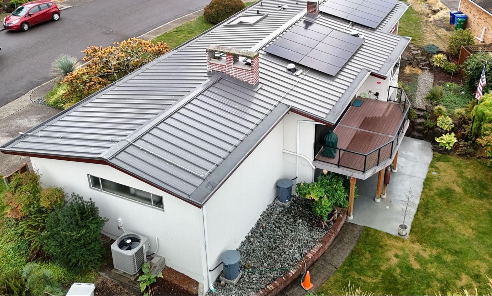 Standing seam metal roof with solar panels on a low-slope home