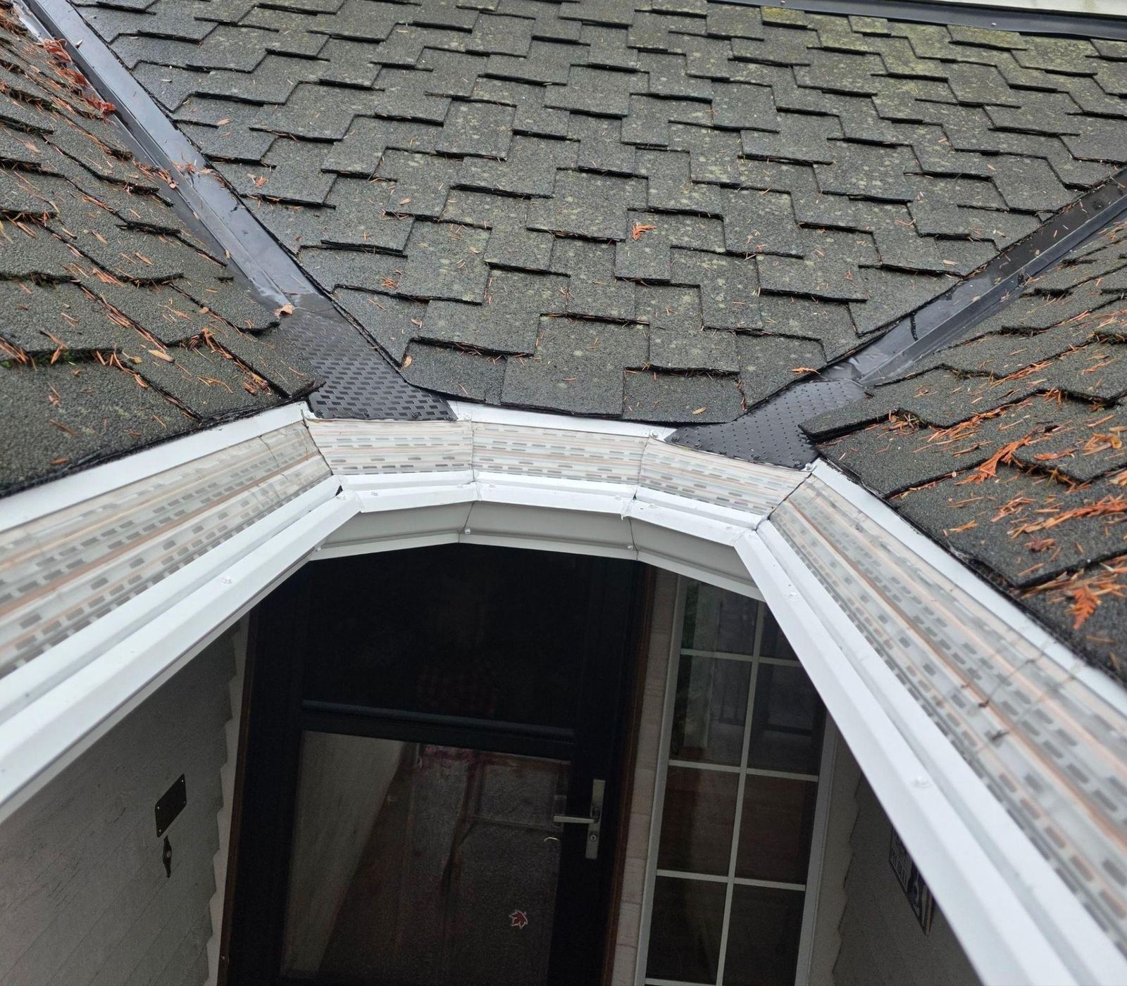 Custom MasterShield corner pieces following an angled section of the roofline above the front entry