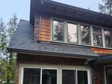 Olympia: street view of the finished asphalt roof on the steep house.