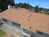 Milton: an elevated view of the finished tan asphalt roof.
